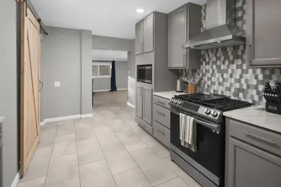 a kitchen with a stove and a counter top at Spacious home near Anschutz/DIA in Aurora