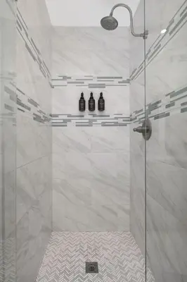 a bathroom with a shower with three bottles on a shelf at Spacious home near Anschutz/DIA in Aurora