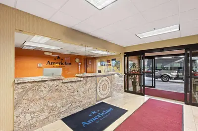 a lobby of an amtrak station with a stone counter at AmericInn by Wyndham Denver Airport in Denver