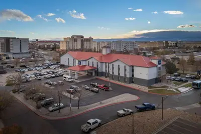 an aerial view of a parking lot in a city at AmericInn by Wyndham Denver Airport in Denver