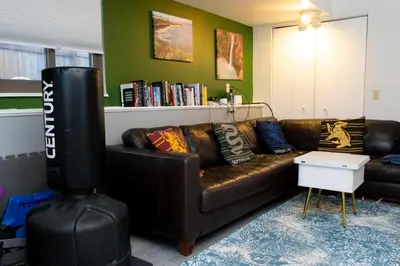a living room with a brown leather couch and a book shelf at 2B2B pet-friendly with views near dog park in Westminster