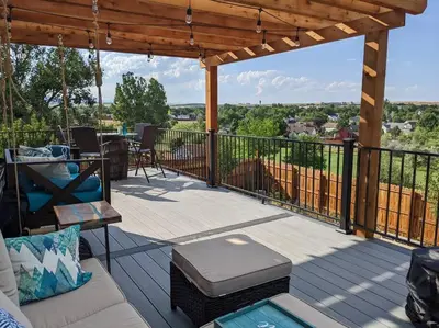 a patio with a couch and a table on a deck at 2B2B pet-friendly with views near dog park in Westminster