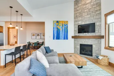 a living room with a couch and a fireplace at Winter Park Retreat Balcony, Hot Tub and Fireplace! in Fraser