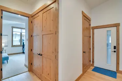 an open hallway with wooden doors and a room at Winter Park Retreat Balcony, Hot Tub and Fireplace! in Fraser