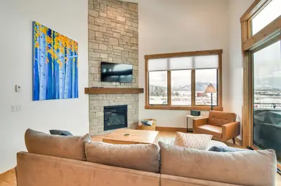 a living room with a couch and a fireplace at Winter Park Retreat Balcony, Hot Tub and Fireplace! in Fraser
