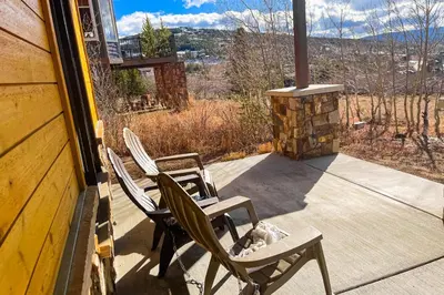 two chairs and a table on the porch of a house at Lone Eagle in Granby