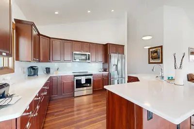 a large kitchen with wooden cabinets and white counter tops at Lone Eagle in Granby