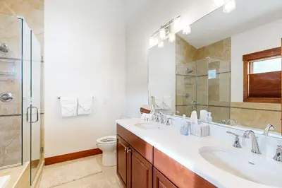 a bathroom with two sinks and a glass shower at Lone Eagle in Granby