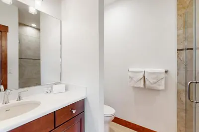 a bathroom with a sink and a toilet and a mirror at Lone Eagle in Granby