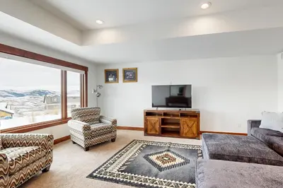 a living room with a couch and a tv at Lone Eagle in Granby