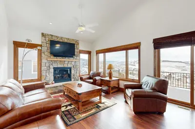 a living room with leather furniture and a fireplace at Lone Eagle in Granby