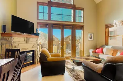 a living room with a fireplace and a tv at Antlers Gulch Townhomes #71 in Keystone