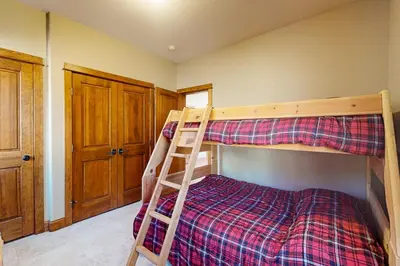 a bedroom with two bunk beds and a ladder at Antlers Gulch Townhomes #71 in Keystone
