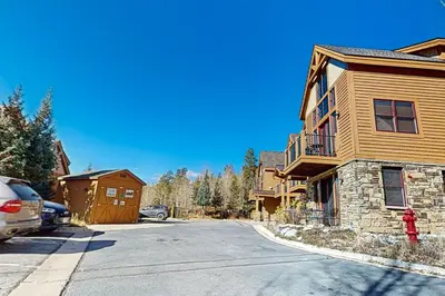 a house with a car parked in front of a street at Antlers Gulch Townhomes #71 in Keystone