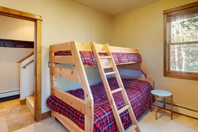 a bedroom with two bunk beds and a ladder at Antlers Gulch Townhomes #71 in Keystone