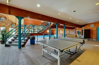 a ping pong table in a room with a staircase at Heated Pool Access and Near Skiing Colorado Retreat in Silverthorne