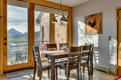 a dining room with a table and chairs and a window at Heated Pool Access and Near Skiing Colorado Retreat in Silverthorne