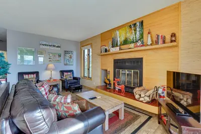 a living room with a leather couch and a fireplace at Heated Pool Access and Near Skiing Colorado Retreat in Silverthorne