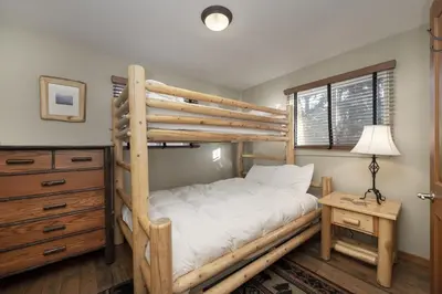 a bedroom with a bunk bed and a dresser at Hi Country Haus - 10-18,,, condo in Winter Park