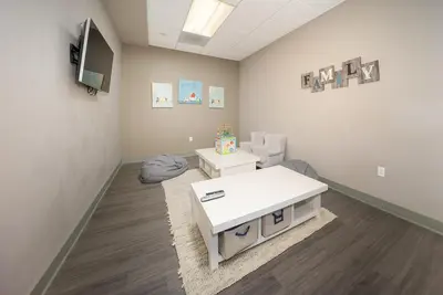 a waiting room with a white table and chairs at Hi Country Haus - 10-18,,, condo in Winter Park