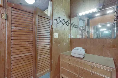 a bathroom with a dresser and a mirror at Red Feather Lakes Cabin with Deck and Views! in Red Feather Lakes