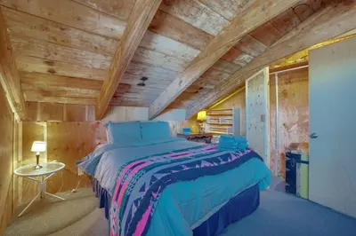 a bedroom with a bed and a wooden ceiling at Red Feather Lakes Cabin with Deck and Views! in Red Feather Lakes