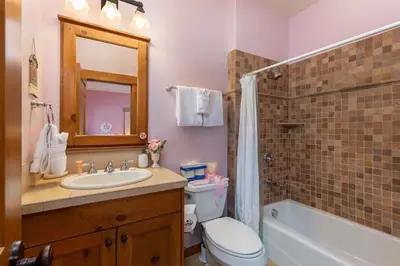 a bathroom with a sink and a toilet and a mirror at 45 Thackwell Lane townhouse in Keystone
