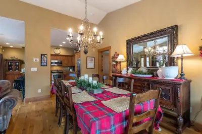a dining room with a table and a mirror at 45 Thackwell Lane townhouse in Keystone