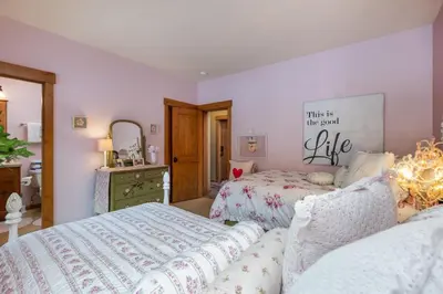 a bedroom with two beds and a mirror at 45 Thackwell Lane townhouse in Keystone