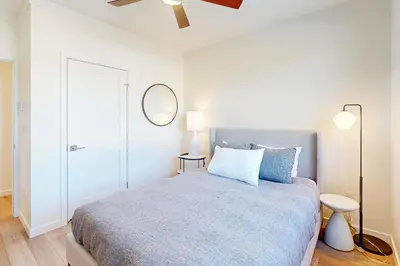 a bedroom with a bed and a mirror on the wall at Mellow on Meadow Mile in Fraser
