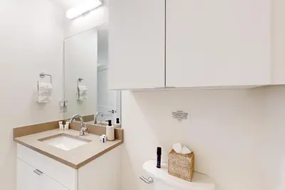 a bathroom with a sink and a toilet and a mirror at Mellow on Meadow Mile in Fraser
