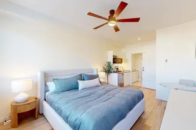 a bedroom with a bed and a ceiling fan at Mellow on Meadow Mile in Fraser