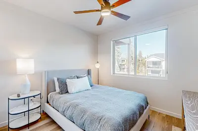 a bedroom with a bed and a ceiling fan at Mellow on Meadow Mile 2A in Fraser