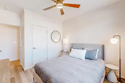 a bedroom with a bed and a ceiling fan at Mellow on Meadow Mile 2A in Fraser
