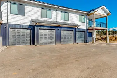 a house with two garage doors in a driveway at Mellow on Meadow Mile 2A in Fraser