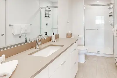 a white bathroom with a sink and a toilet at Mellow on Meadow Mile 2B in Fraser
