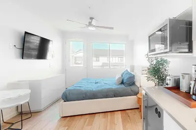 a small bedroom with a bed in a kitchen at Mellow on Meadow Mile 2B in Fraser