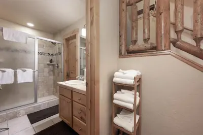 a bathroom with a sink and a shower and towels at Antler Way at Lakota,,,, townhouse in Winter Park
