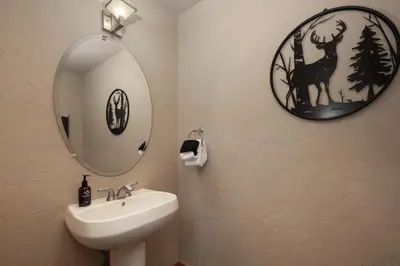 a bathroom with a sink and a mirror on the wall at Antler Way at Lakota,,,, townhouse in Winter Park