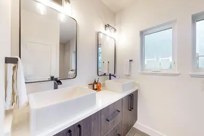 a bathroom with two sinks and a mirror at Mountain Sky in Granby