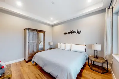 a bedroom with a white bed and a window at Mountain Sky in Granby