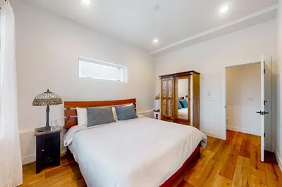 a bedroom with a large white bed and a mirror at Mountain Sky in Granby