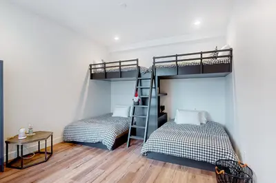 two beds in a room with a bunk bed at Mountain Sky in Granby