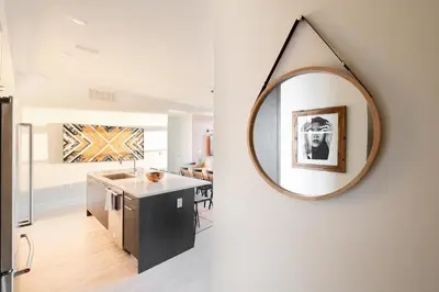 a mirror hanging on a wall in a kitchen at Bold & Elevated | Espadin LoHi in Denver
