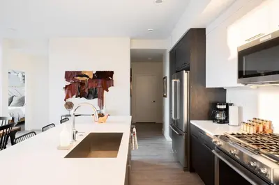 a white kitchen with a sink and a stove at Bold & Elevated | Espadin LoHi in Denver