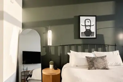 a bedroom with a bed with a black and green wall at Bold & Elevated | Espadin LoHi in Denver