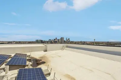 a rooftop with solar panels and a view of the city at Bold & Elevated | Espadin LoHi in Denver