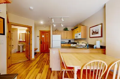 a kitchen with a wooden table and a counter top at Mountainside Majesty in Keystone