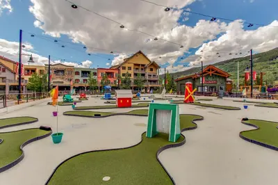 an empty playground in a town with buildings at Mountainside Majesty in Keystone