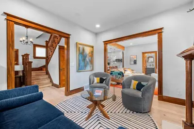a living room with a blue couch and two chairs at Race St - Denver in Denver